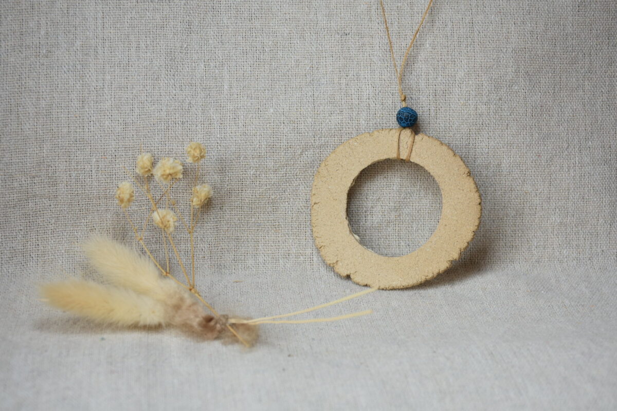 Handmade Ceramic Donut Necklace | Earthy Clay Circle Pendant with Blue Bead Handmade Ceramic Donut Necklace | Earthy Clay Circle Pendant with Blue Bead