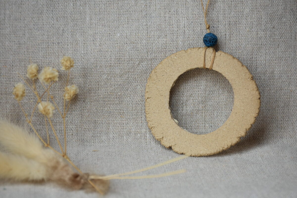 Handmade Ceramic Donut Necklace | Earthy Clay Circle Pendant with Blue Bead Handmade Ceramic Donut Necklace | Earthy Clay Circle Pendant with Blue Bead