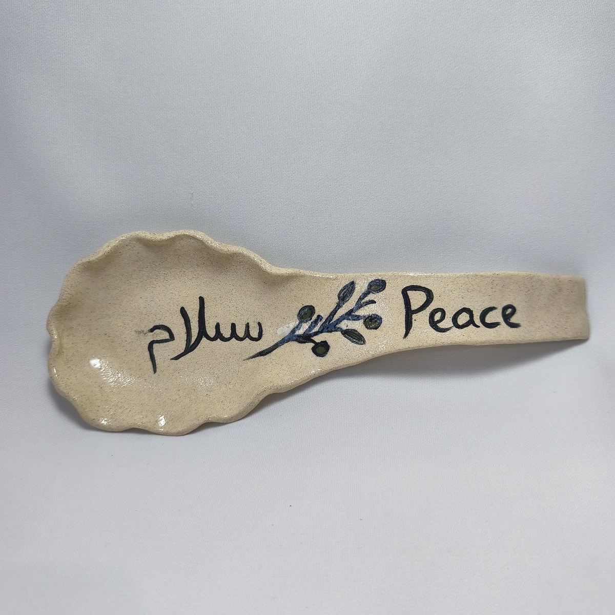 Handmade Ceramic Spoon Rest | Peace & Salam Olive Branch Pottery Handmade Ceramic Spoon Rest | Peace & Salam Olive Branch Pottery